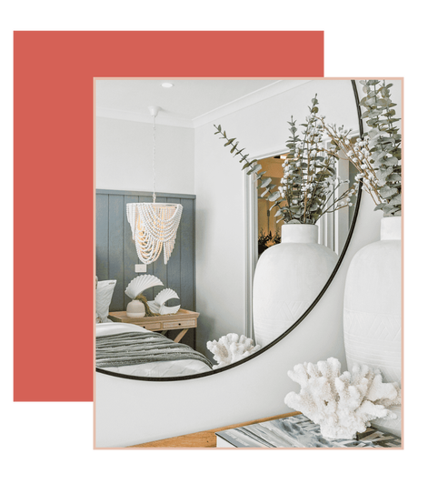 Image of a modern bedroom with vase and flowers reflected in a mirror